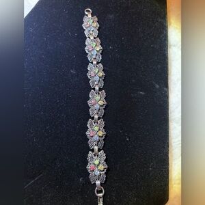 Vintage silver-tone panel bracelet with floral design and colorful rhinestones
